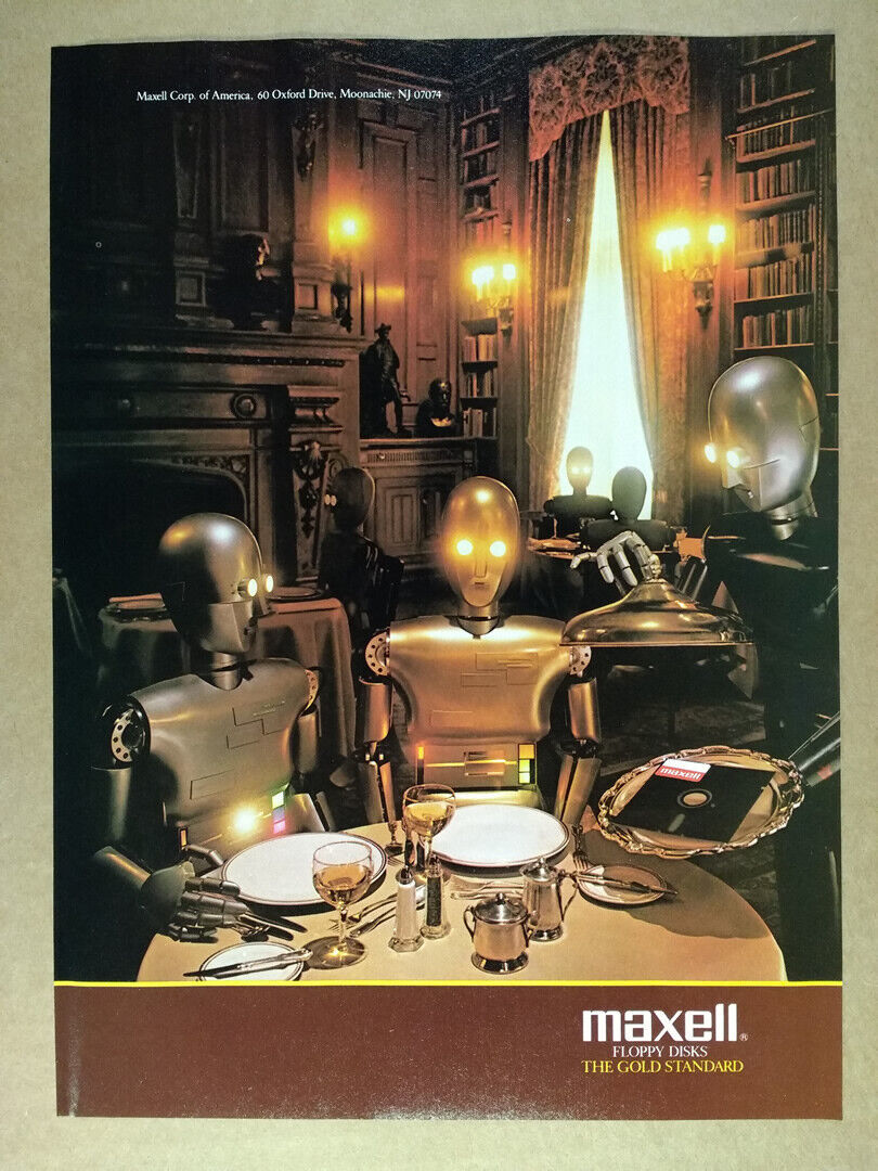 Два робота (один золотой, один серебряный) сидят в романтической обстановке в ресторане с приглушённым освещением. Робот-официант подает двум посетителям блюдо, на котором лежит 5,25-дюймовая дискета / WorthPoint